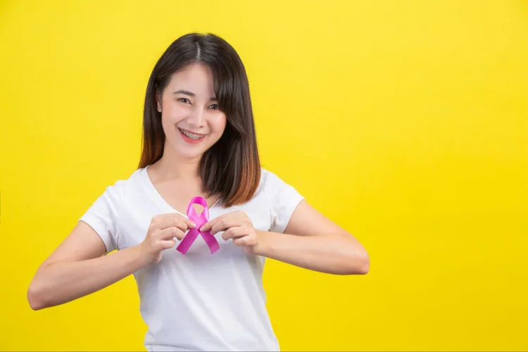 Young asian woman showing support for breast cancer prevention through regular mammogram screenings.